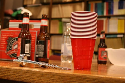 Red plastic cups and bottles on top of the table