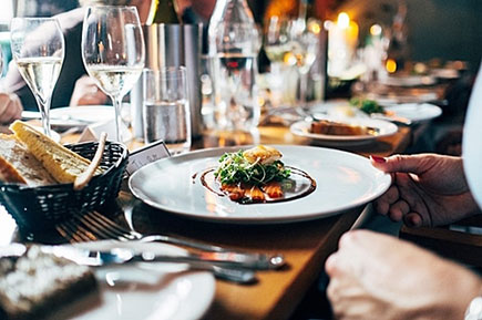 Restaurant plated food and wine glasses
