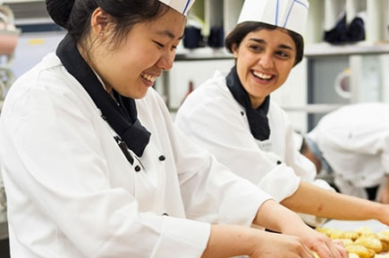 Happy kitchen staffs preparing food