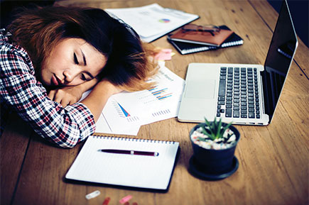 Working woman sleeping at desk