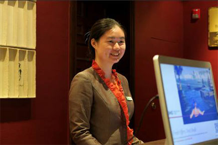 A young woman smiling while at work.
