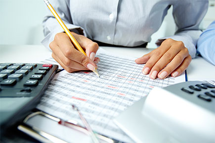 Businesswoman doing finances and planning how to cut wage costs