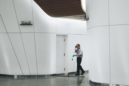Male Janitor Mopping With Wet Floor